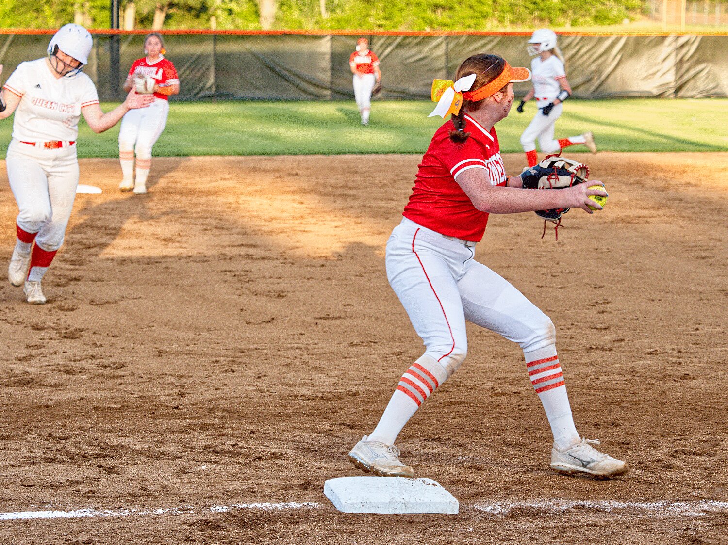 Gracie Finley gets the force out at third before firing to first base.